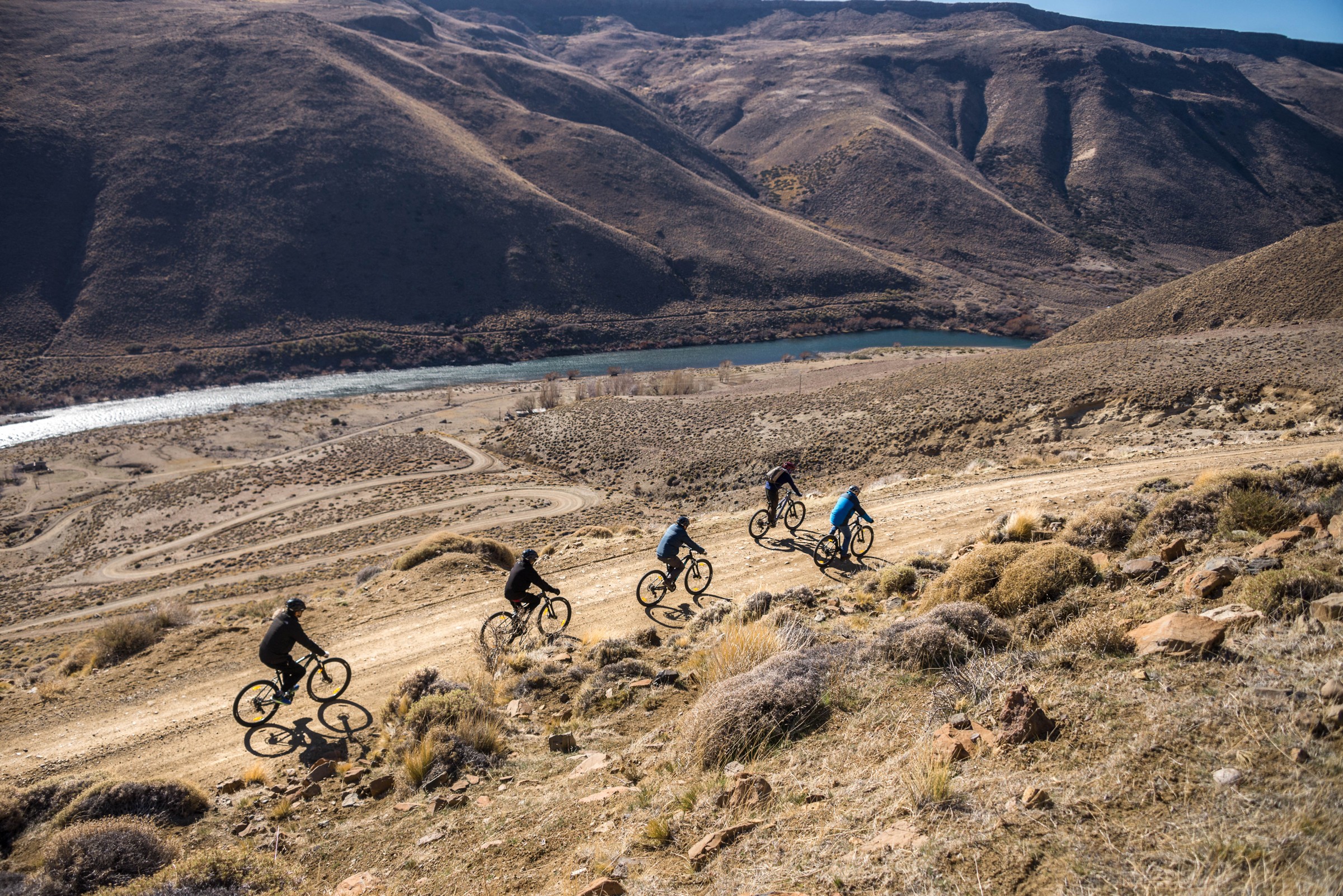 Travelers cycling through an open mountain landscape